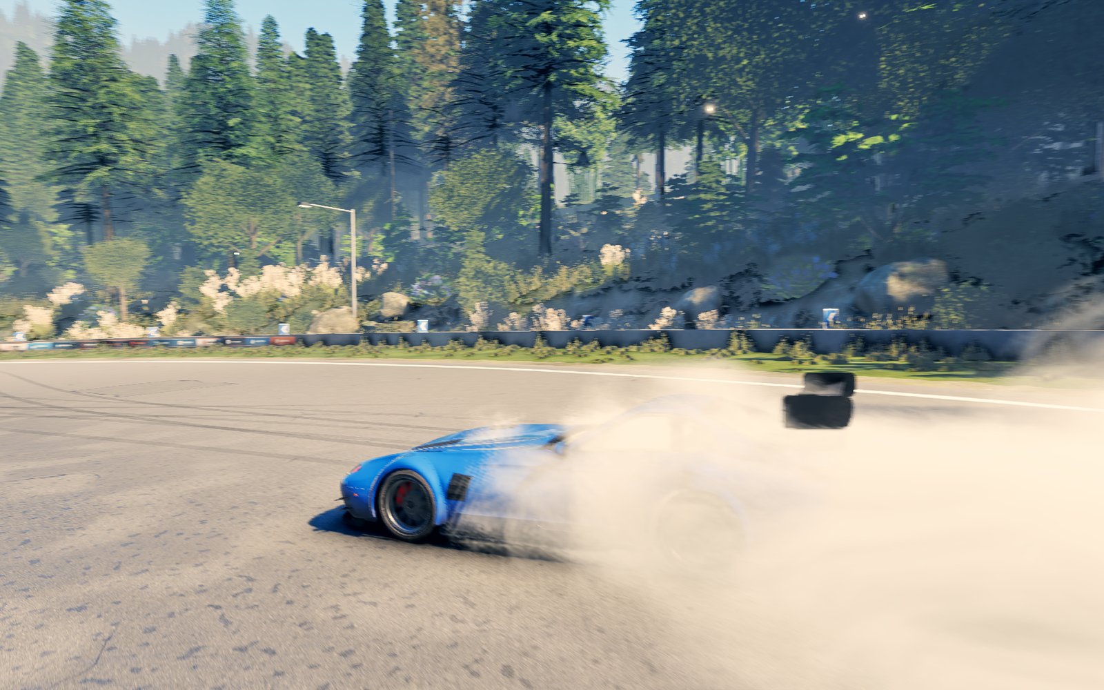 The car sliding sideways through a mountain corner at full lock
